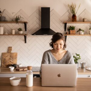 Woman working on a Mac in the Kitchen