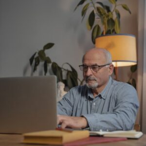 Older Man Working From Home on a Laptop