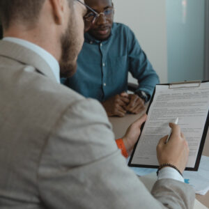 Man helping another one write his resume