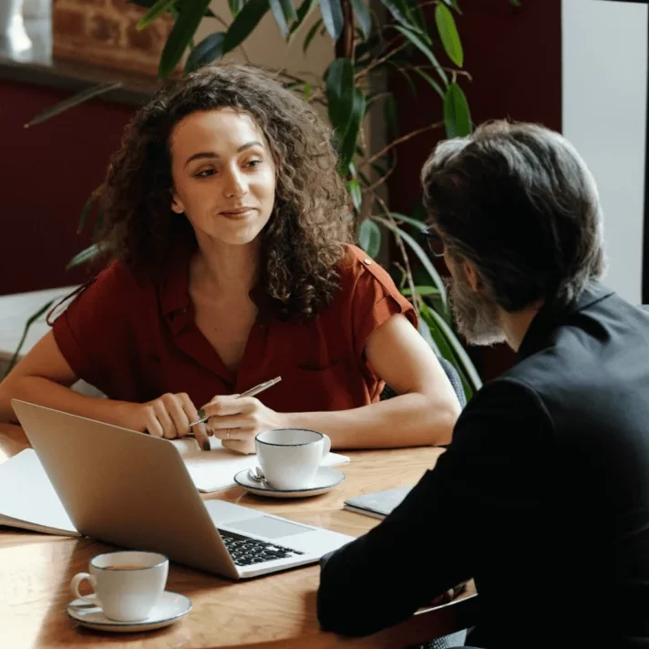 people working over coffee with a laptop