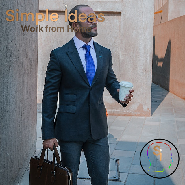 Man in a suit carrying a suitcase and a coffee