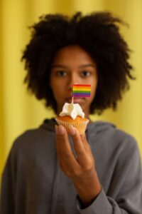 Black woman holding a cupcake