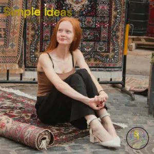Woman sitting on a carpet in the street