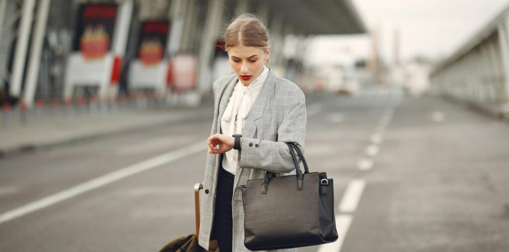 Worried young woman with suitcase hurrying on flight